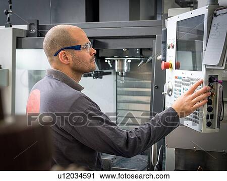 Knife factory worker operating machine control panel in workshop View Large Photo Image Stock Image - Knife factory worker operating machine control panel in workshop. Fotosearch