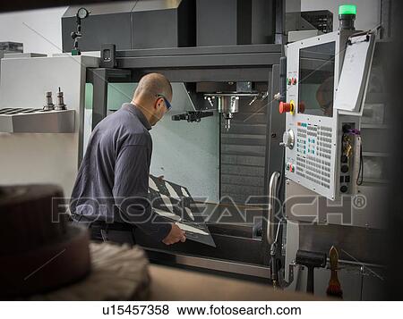Knife factory worker preparing machinery View Large Photo Image Stock Photo - Knife factory worker preparing machinery. Fotosearch