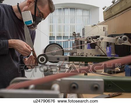 Knife factory worker sanding knife handle in workshop View Large Photo Image Stock Photograph - Knife factory worker sanding knife handle in workshop. Fotosearch