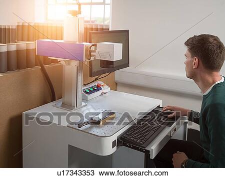 Knife factory worker using computer keyboard to operate laser cutting equipment in workshop View Large Photo Image Stock Image - Knife factory worker using computer keyboard to operate laser cutting equipment in workshop. Fotosearch