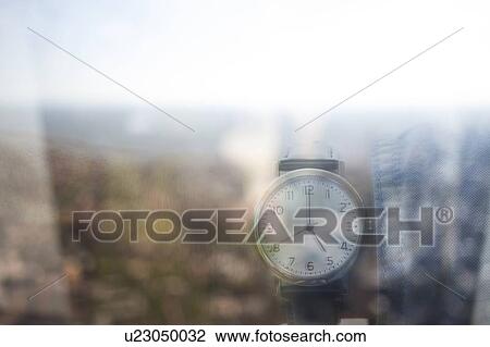 Stock Image - Looking at watch. Fotosearch