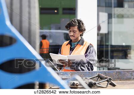 Male engineer on construction site writing in notebook View Large Photo Image Stock Image - Male engineer on construction site writing in notebook. Fotosearch