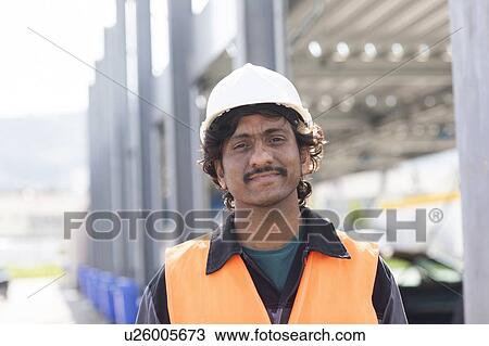 Stock Image - Male engineer on construction site, head and shoulder portrait. Fotosearch