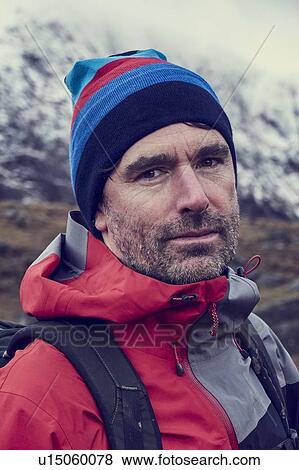 Male hiker in knit hat by snow capped mountains, close up portrait, Llanberis, Gwynedd, Wales View Large Photo Image Stock Photo - Male hiker in knit hat by snow capped mountains, close up portrait, Llanberis, Gwynedd, Wales. Fotosearch