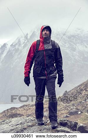 Male hiker looking up while hiking in rugged landscape with snow capped mountains, Llanberis, Gwynedd, Wales View Large Photo Image Stock Image - Male hiker looking up while hiking in rugged landscape with snow capped mountains, Llanberis, Gwynedd, Wales. Fotosearch