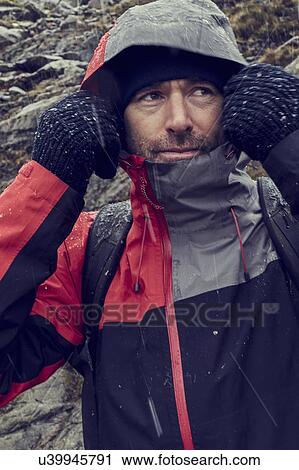 Male hiker pulling hood up in sleeting rugged landscape, close up, Llanberis, Gwynedd, Wales View Large Photo Image Stock Image - Male hiker pulling hood up in sleeting rugged landscape, close up, Llanberis, Gwynedd, Wales. Fotosearch