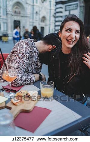 Stock Photo - Man leaning head against shoulder of woman in cafe, Santa Maria del Fiore, Firenze, Toscana, Italy. Fotosearch