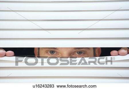 Man peeking through venetian blinds View Large Photo Image Stock Image - Man peeking through venetian blinds. Fotosearch