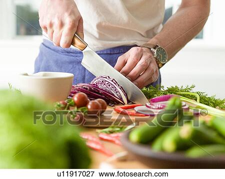 Man slicing red cabbage at kitchen counter, mid section View Large Photo Image Stock Photo - Man slicing red cabbage at kitchen counter, mid section. Fotosearch