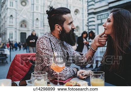 Stock Photo - Man tenderly touching chin of woman in cafe, Santa Maria del Fiore, Firenze, Toscana, Italy. Fotosearch