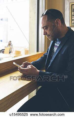 Man using smart phone in cafe View Large Photo Image Stock Photography - Man using smart phone in cafe. Fotosearch