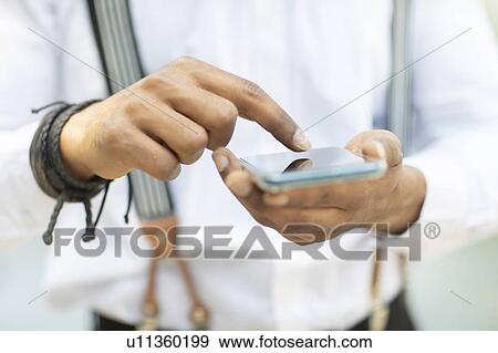 Man using smartphone outdoors View Large Photo Image Stock Photo - Man using smartphone outdoors. Fotosearch