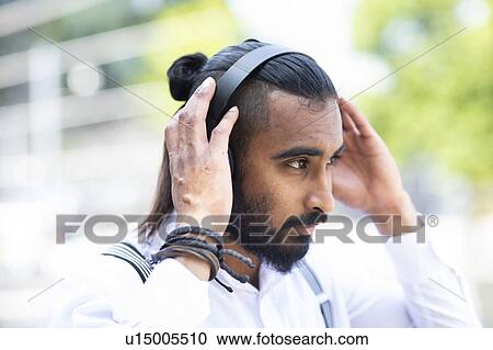 Man with headphones outdoors View Large Photo Image Stock Image - Man with headphones outdoors. Fotosearch