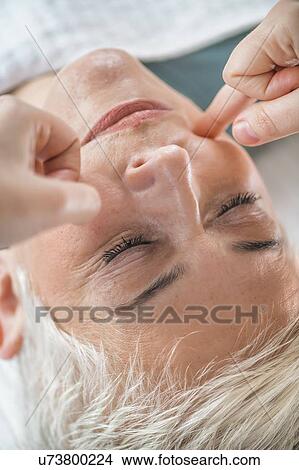 Picture - Marma therapy ayurveda facial massage. Fotosearch