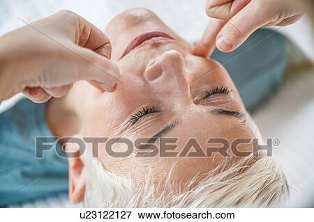 Stock Photo - Marma therapy ayurveda facial massage. Fotosearch