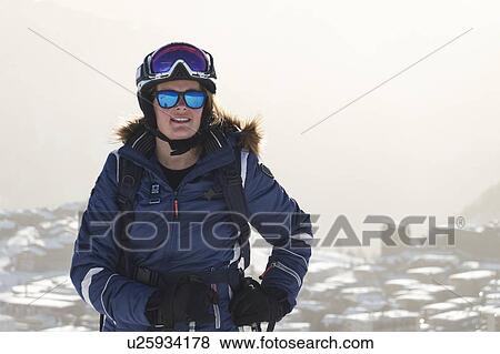 Mature female skier above snow covered rooftops, portrait, Alpe-d'Huez, Rhone-Alpes, France View Large Photo Image Stock Photo - Mature female skier above snow covered rooftops, portrait, Alpe-d'Huez, Rhone-Alpes, France. Fotosearch