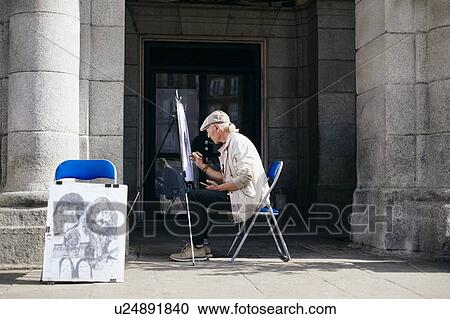 Mature male street artist drawing on canvas by building entrance, Madrid, Spain View Large Photo Image Stock Image - Mature male street artist drawing on canvas by building entrance, Madrid, Spain. Fotosearch