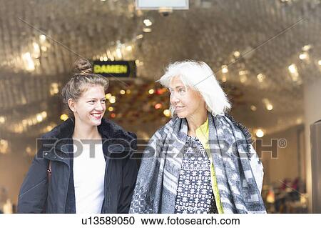 Mature woman and daughter leaving shop in city View Large Photo Image Stock Image - Mature woman and daughter leaving shop in city. Fotosearch