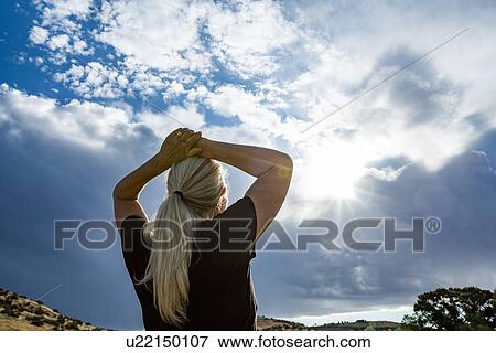 Mature woman with her hands on her head View Large Photo Image Stock Photo - Mature woman with her hands on her head. Fotosearch