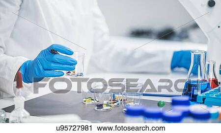 Stock Image - Medical researcher testing new medicine. Fotosearch