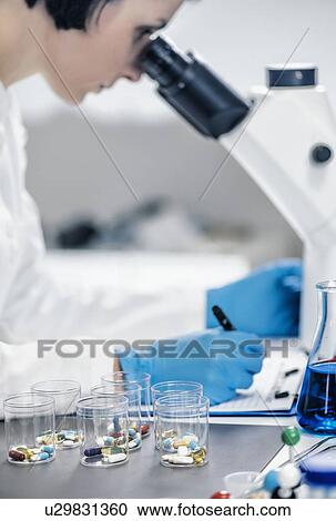 Medical researcher using microscope View Large Photo Image Stock Image - Medical researcher using microscope. Fotosearch
