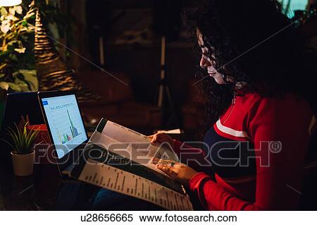 Mid adult woman looking at menu at cafe table View Large Photo Image Stock Photography - Mid adult woman looking at menu at cafe table. Fotosearch