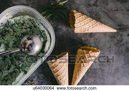 Picture - Mint chocolate chip ice cream with cones. Fotosearch