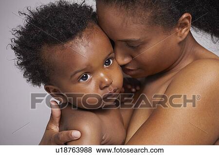 Stock Photo - Mother hugging baby boy. Fotosearch
