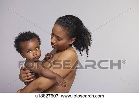 Stock Photo - Mother hugging baby boy. Fotosearch