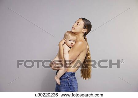Mother hugging baby View Large Photo Image Stock Photograph - Mother hugging baby. Fotosearch