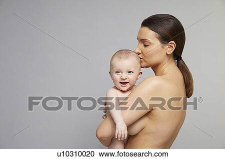 Mother kissing baby on head View Large Photo Image Stock Image - Mother kissing baby on head. Fotosearch