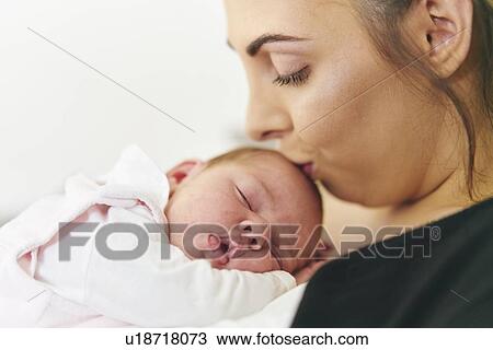 Mother kissing baby's head View Large Photo Image Stock Image - Mother kissing baby's head. Fotosearch