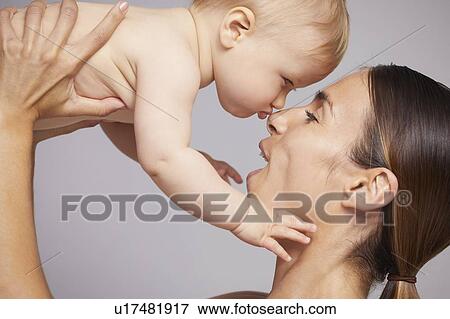 Mother nuzzling baby View Large Photo Image Stock Photo - Mother nuzzling baby. Fotosearch