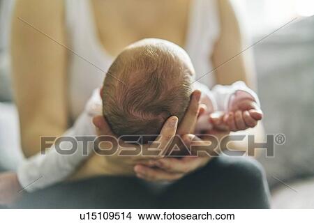 Mother supporting head of baby on lap View Large Photo Image Picture - Mother supporting head of baby on lap. Fotosearch