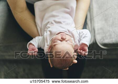 Mother supporting head of baby on lap View Large Photo Image Stock Photography - Mother supporting head of baby on lap. Fotosearch