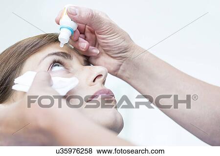 Ophthalmologist applying eye drops View Large Photo Image Stock Photo - Ophthalmologist applying eye drops. Fotosearch
