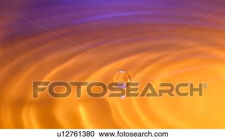Stock Image - Orange and purple splashing water. Fotosearch