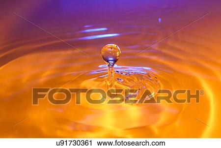 Stock Image - Orange and purple splashing water. Fotosearch