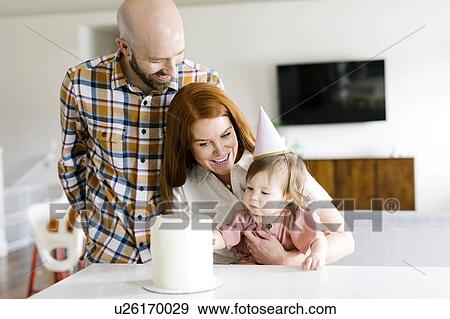Parents and daughter with birthday cake View Large Photo Image Stock Photo - Parents and daughter with birthday cake. Fotosearch