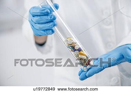Pharmaceuticals glass test tube filled with colourful pills View Large Photo Image Stock Photo - Pharmaceuticals glass test tube filled with colourful pills. Fotosearch