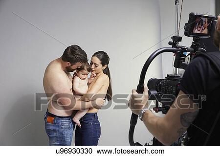 Photographer taking portrait of couple and baby girl View Large Photo Image Stock Image - Photographer taking portrait of couple and baby girl. Fotosearch