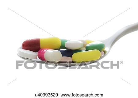 Stock Photo - Pills and capsules on spoon. Fotosearch