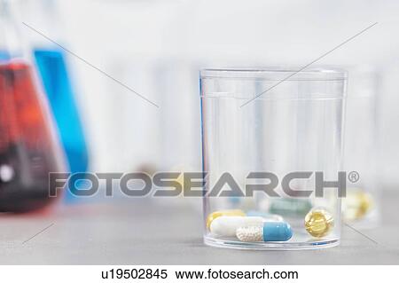 Stock Photography - Pills in a disposable plastic cup. Fotosearch