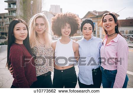 Stock Image - Portrait of friends in street, Milan, Italy. Fotosearch