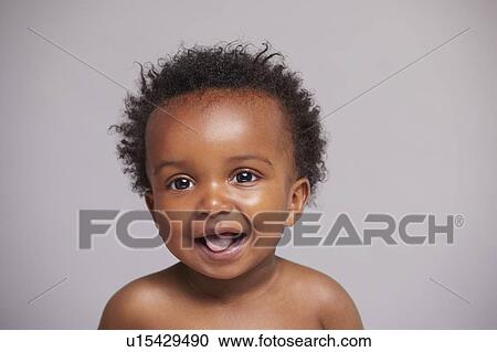 Stock Image - Portrait of laughing baby boy. Fotosearch