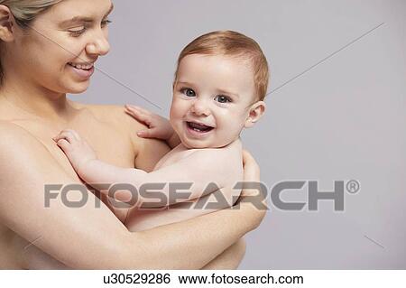 Stock Photograph - Portrait of mother and laughing baby boy. Fotosearch