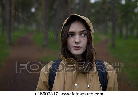 Portrait of young woman wearing brown raincoat View Large Photo Image Stock Photo - Portrait of young woman wearing brown raincoat. Fotosearch