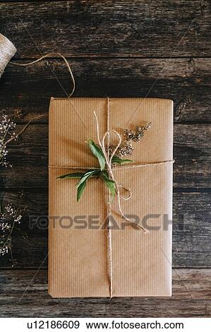Present wrapped in brown paper with string and flowers View Large Photo Image Stock Photo - Present wrapped in brown paper with string and flowers. Fotosearch