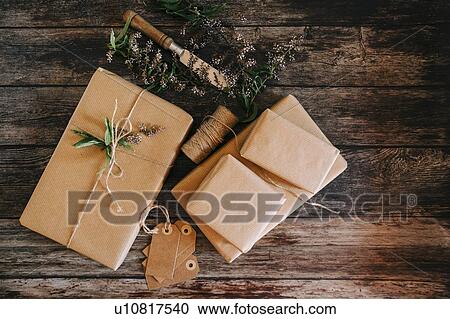 Presents wrapped in brown paper and string with labels and flowers View Large Photo Image Stock Image - Presents wrapped in brown paper and string with labels and flowers. Fotosearch