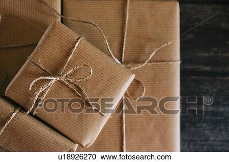 Presents wrapped in brown paper and string View Large Photo Image Stock Image - Presents wrapped in brown paper and string. Fotosearch